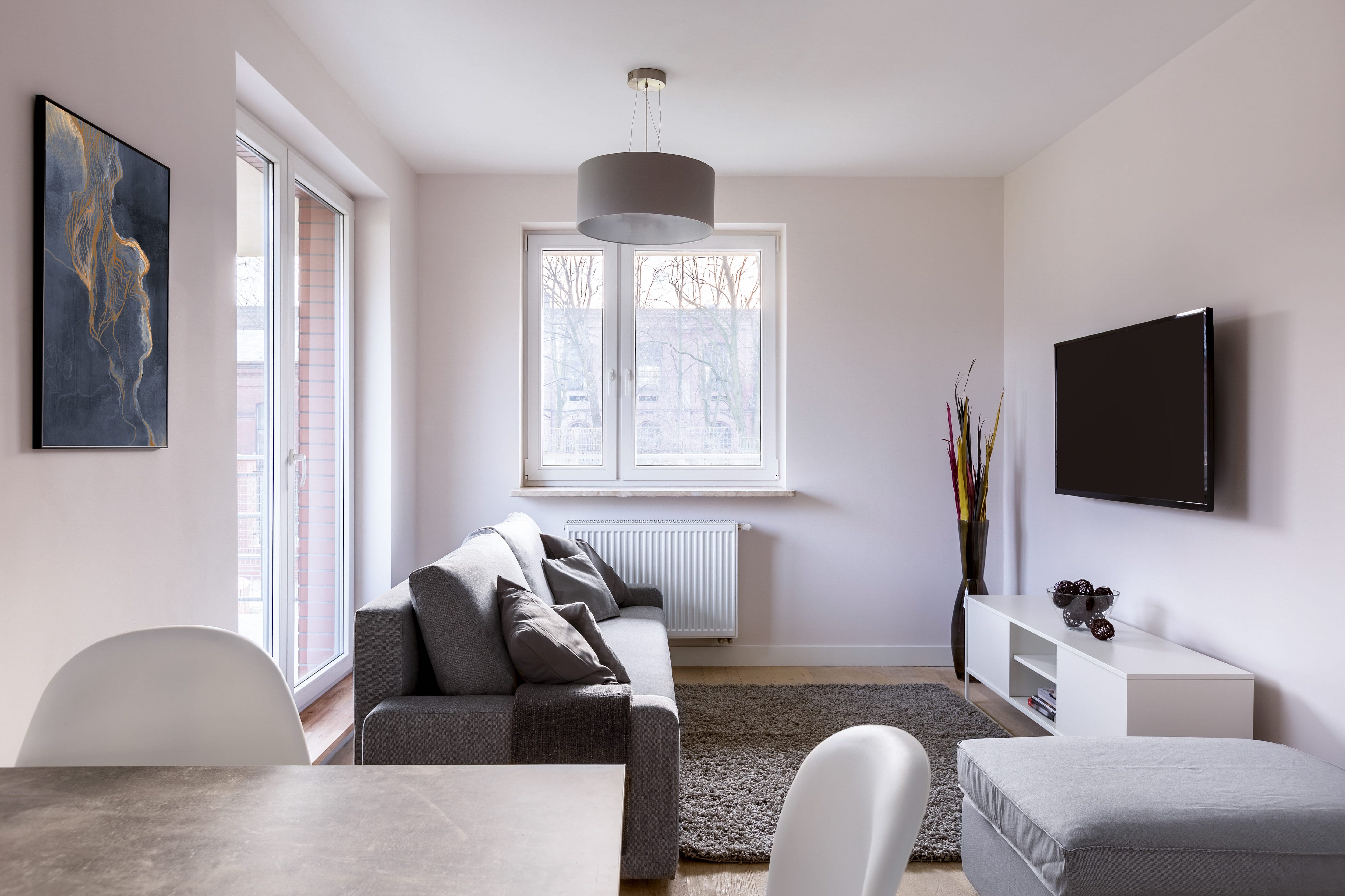 A small living room with neutral colors and natural lighting