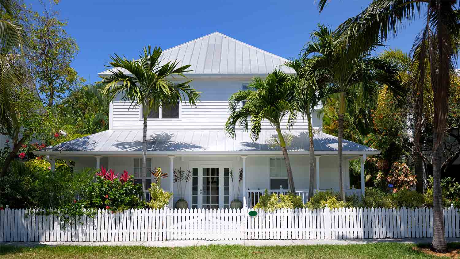 White townhouse with picket fence