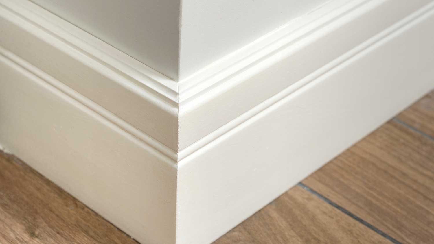 Corner of a house with sculpted baseboard