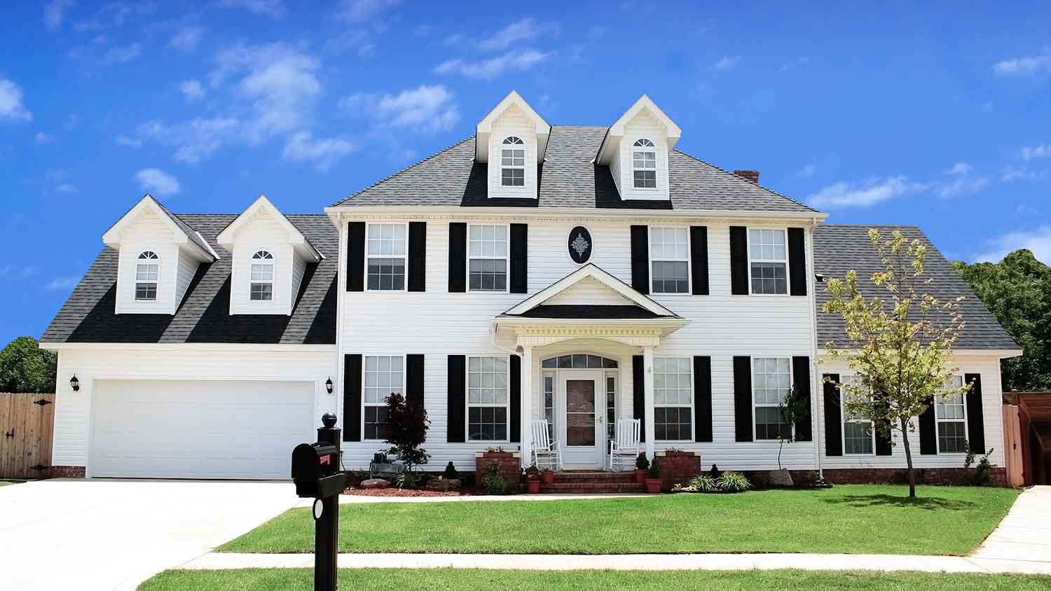 White house with white siding and black window shutters