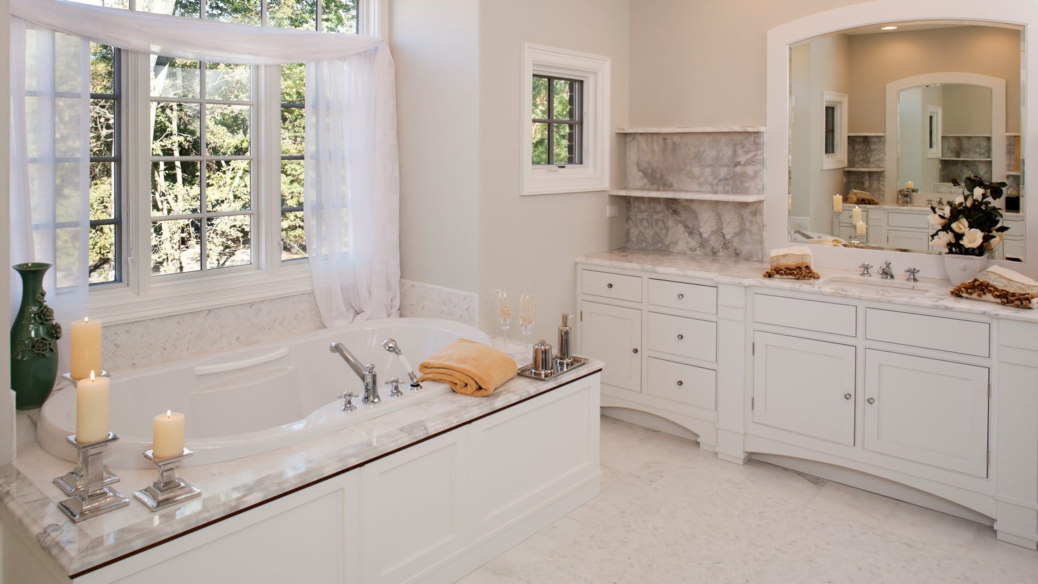 A white toned bathroom with a bathtub