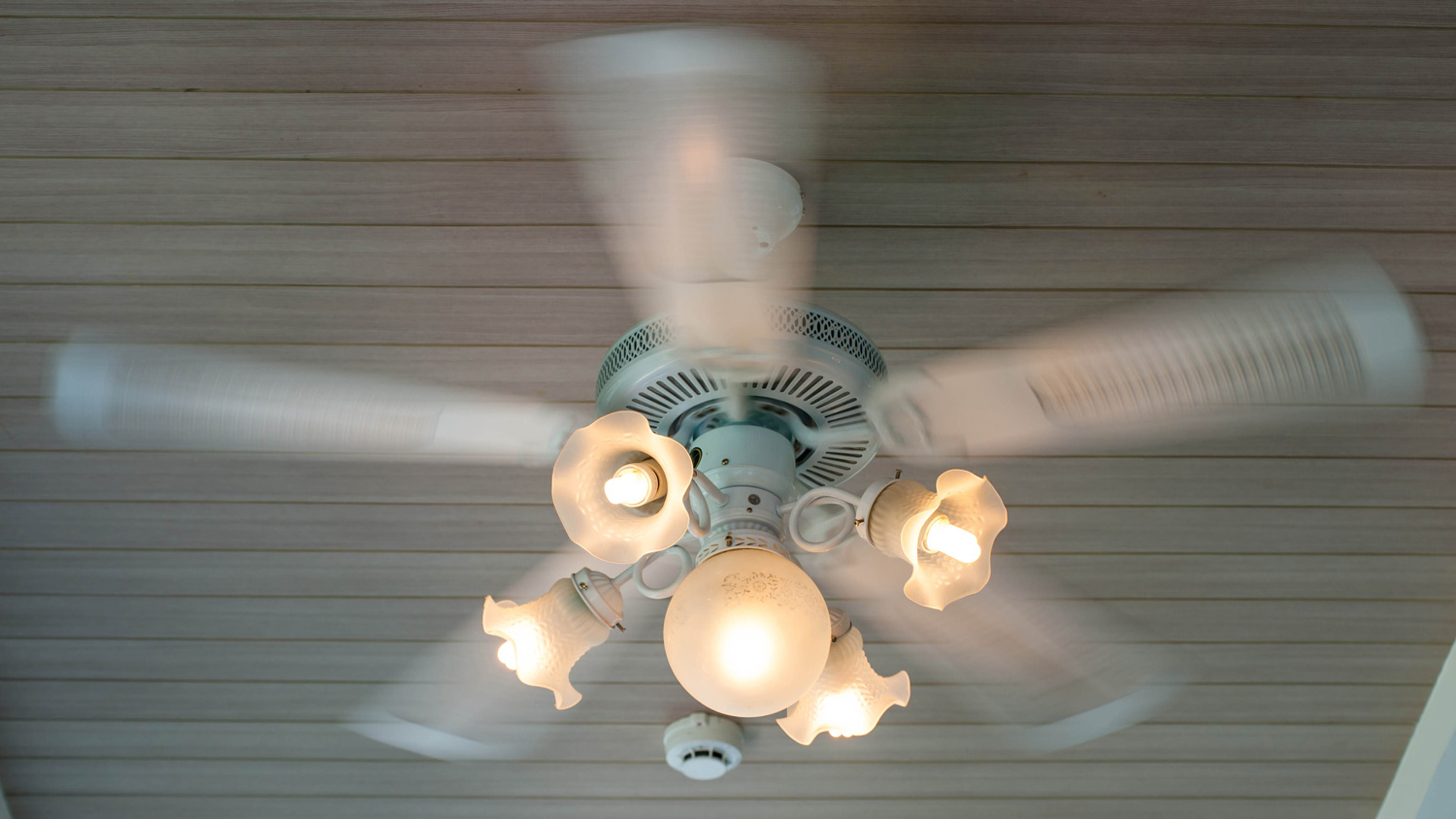 Vintage art deco ceiling lamp and fan fixture in hotel