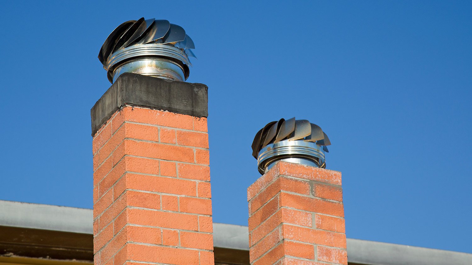 Two Chimney Caps with blue sky as background