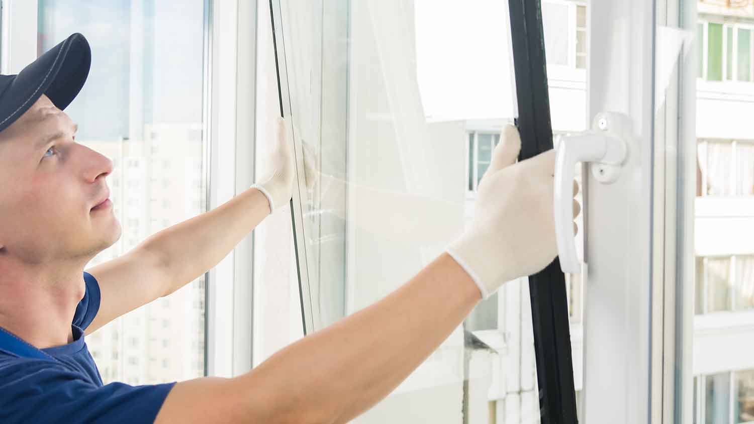 Technician replacing old window in the house