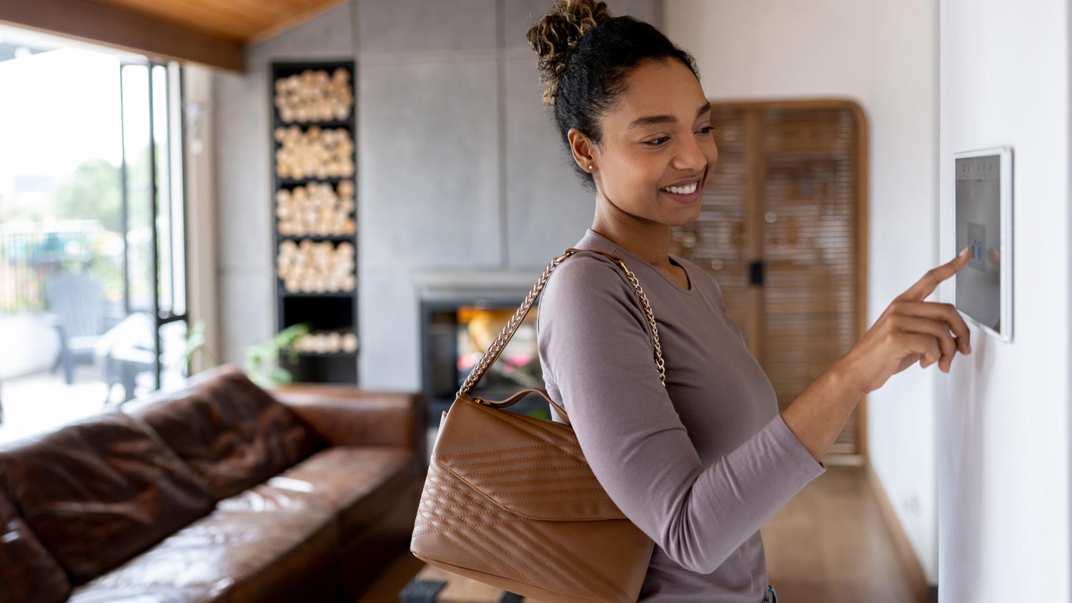 A woman activating the home security system