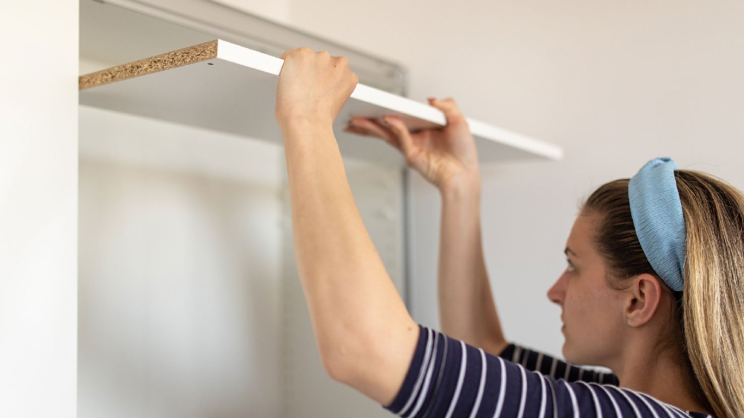 A woman assembling a closet