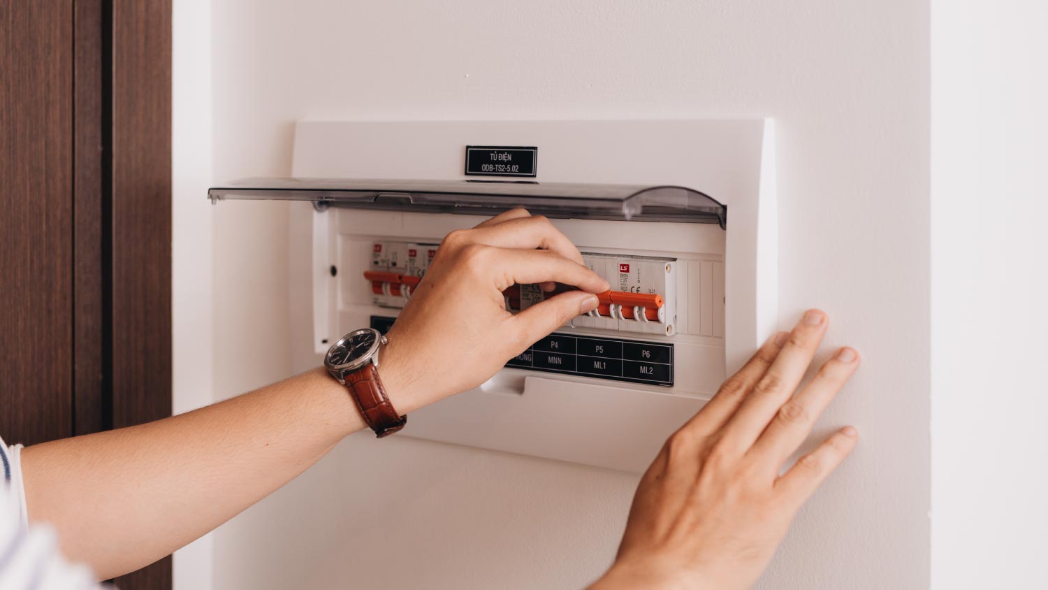 A woman checking electrical panel