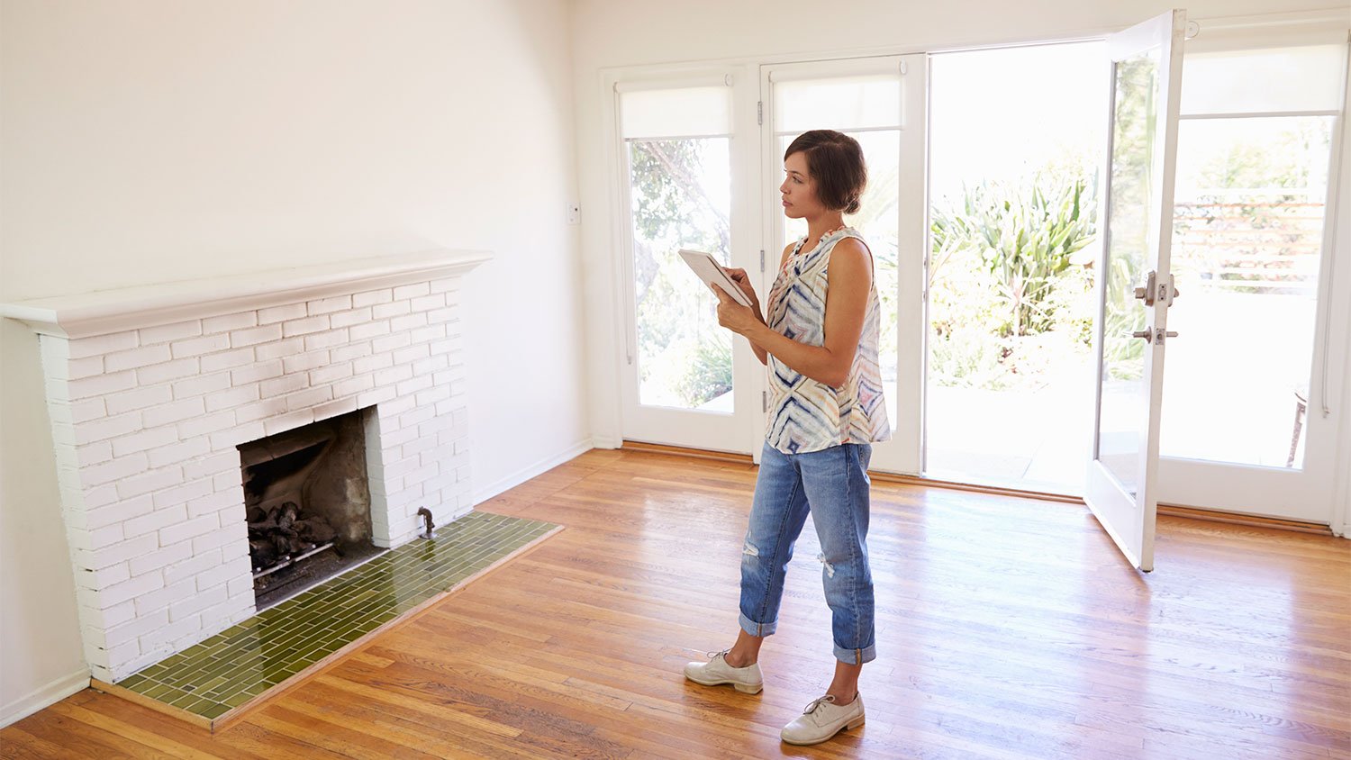 A woman checks an empty house