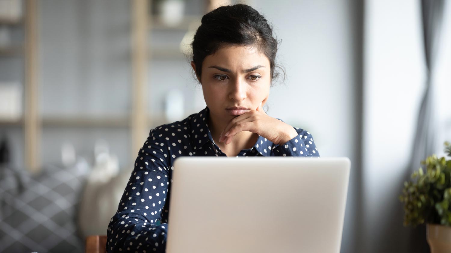 A woman checking reviews on her laptop