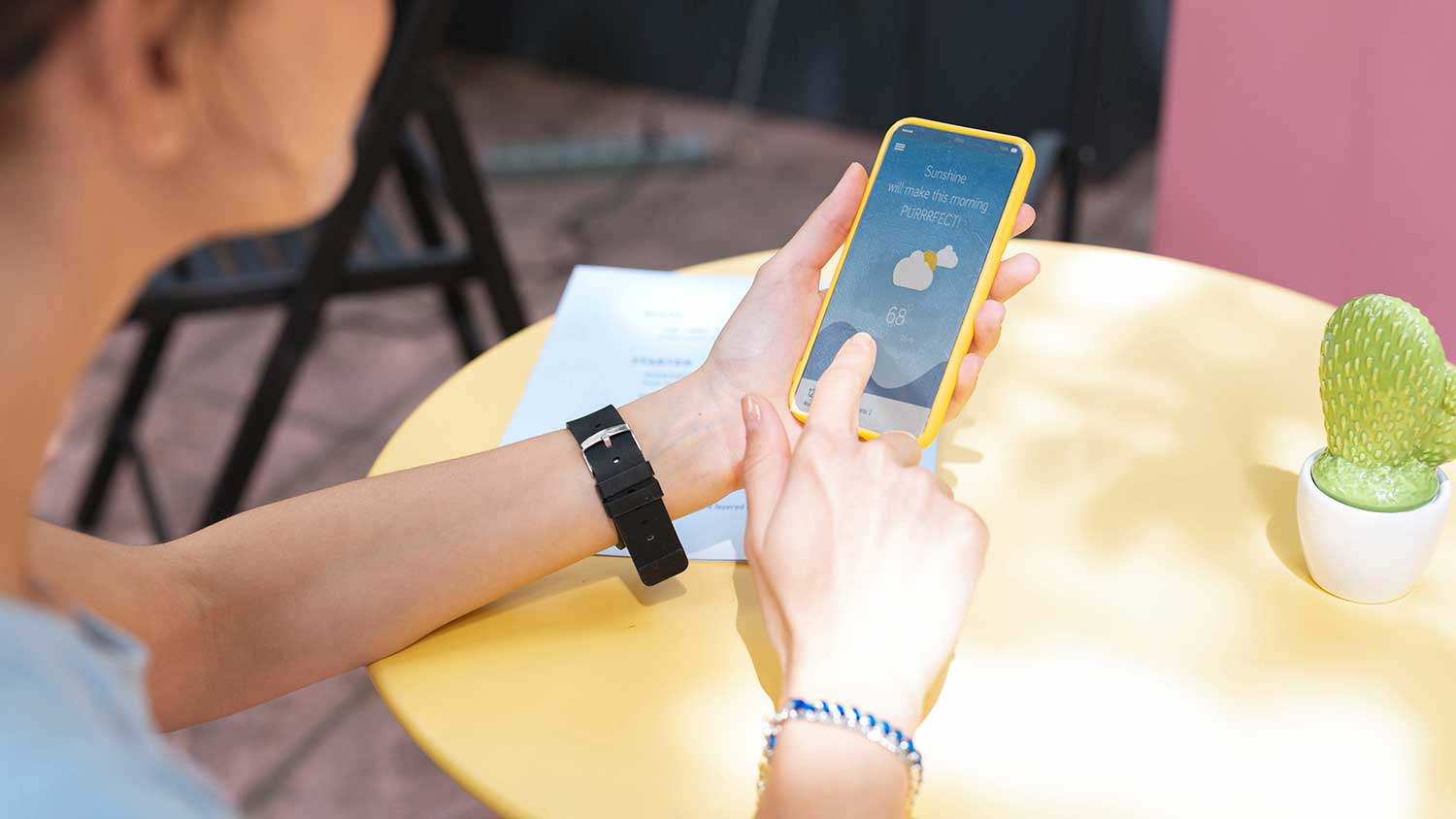 Woman using her phone to check weather forecast