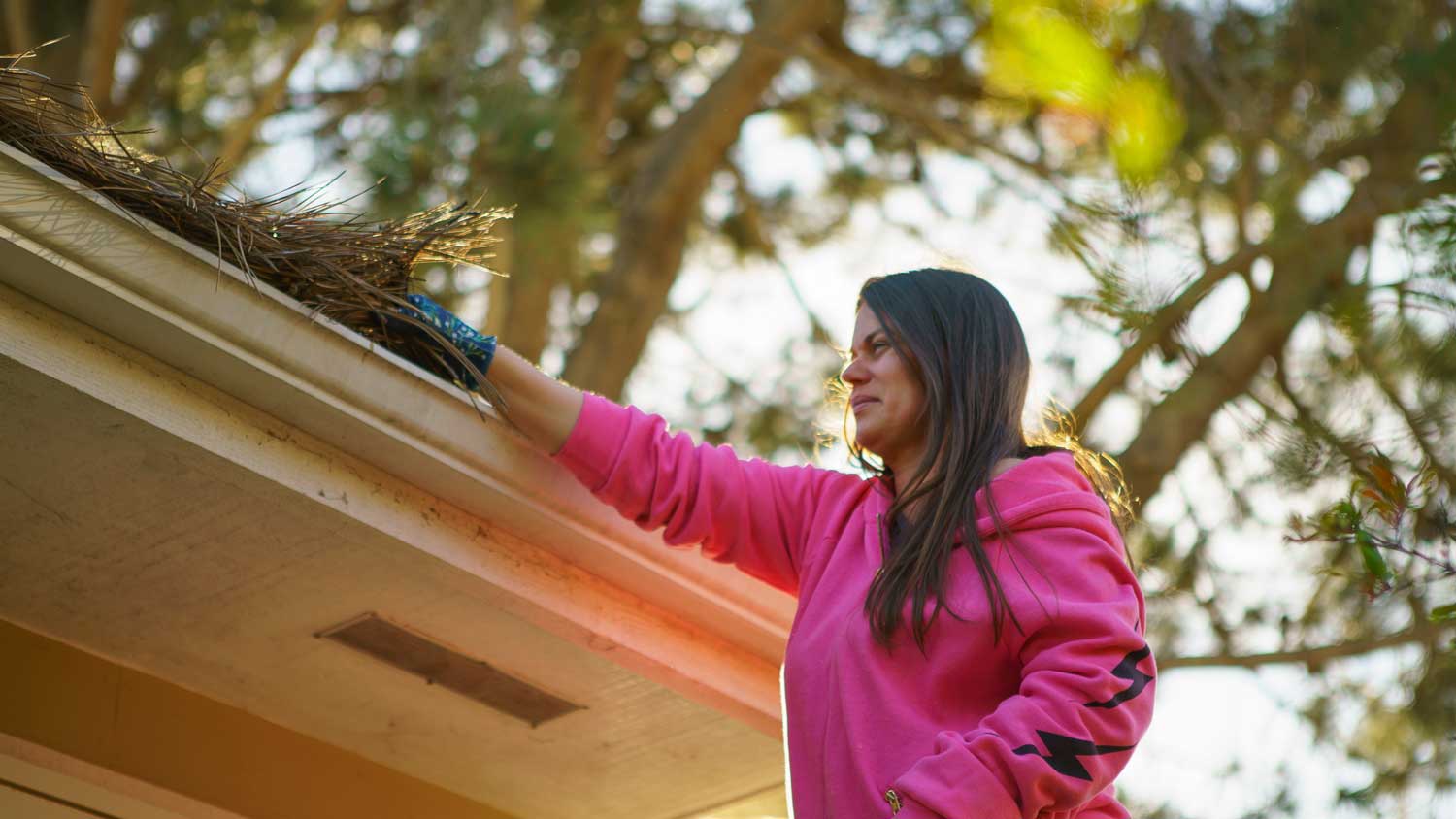 A woman cleaning the gutter