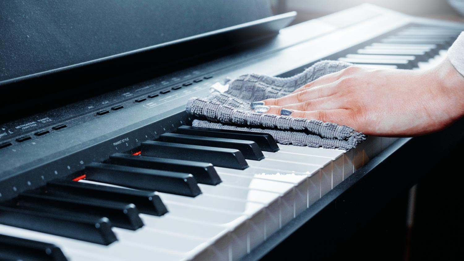 A woman cleaning a piano