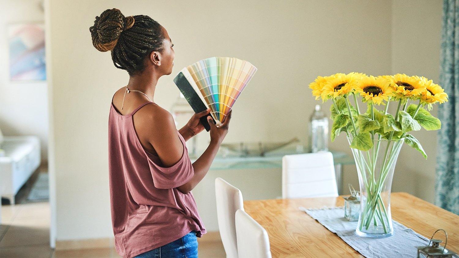 Woman looking at color wheel swatches at home