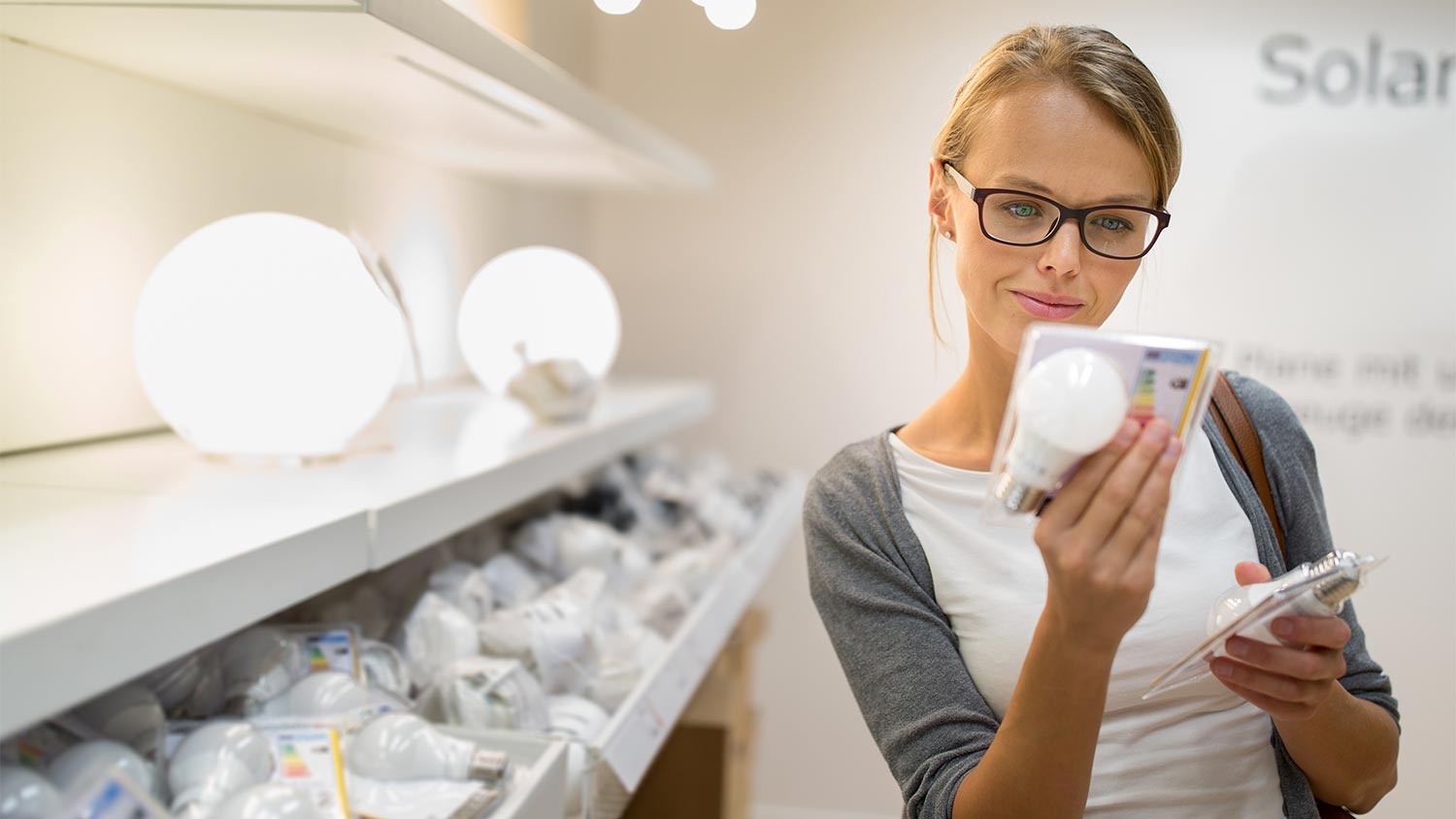 woman comparing led lights in store