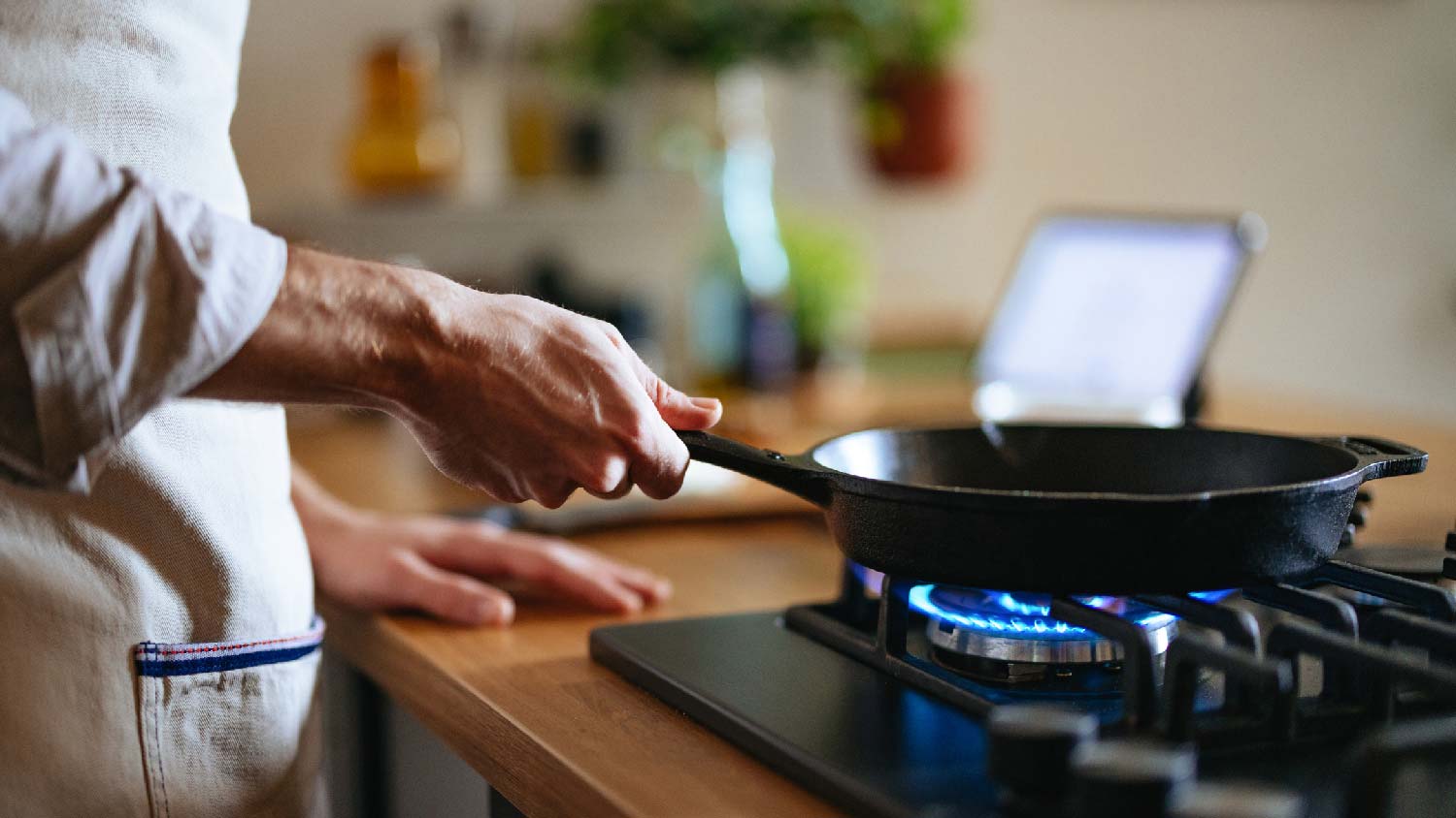 A woman cooking on a gas stove