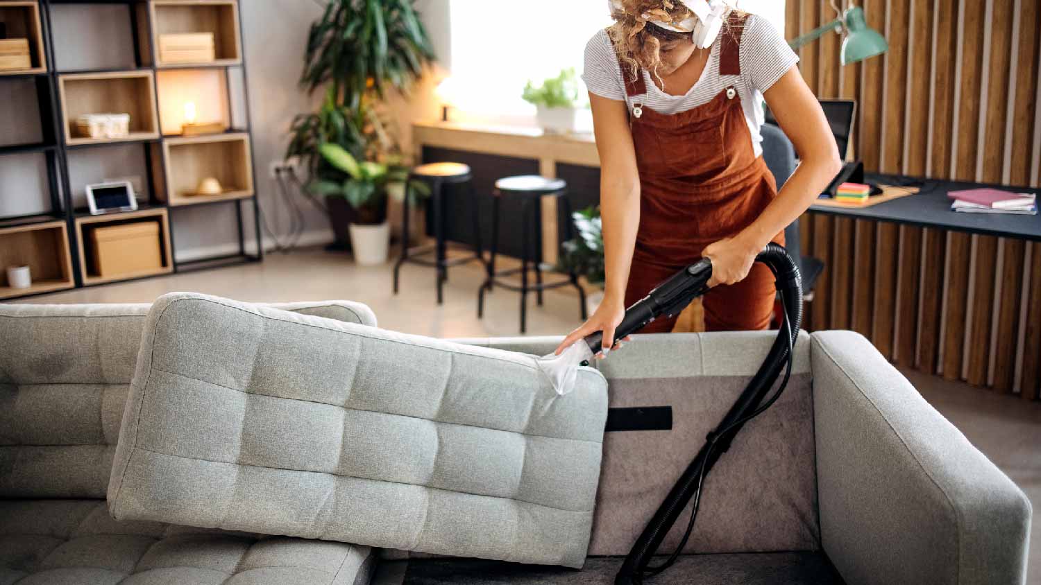 A woman deep cleaning a sofa