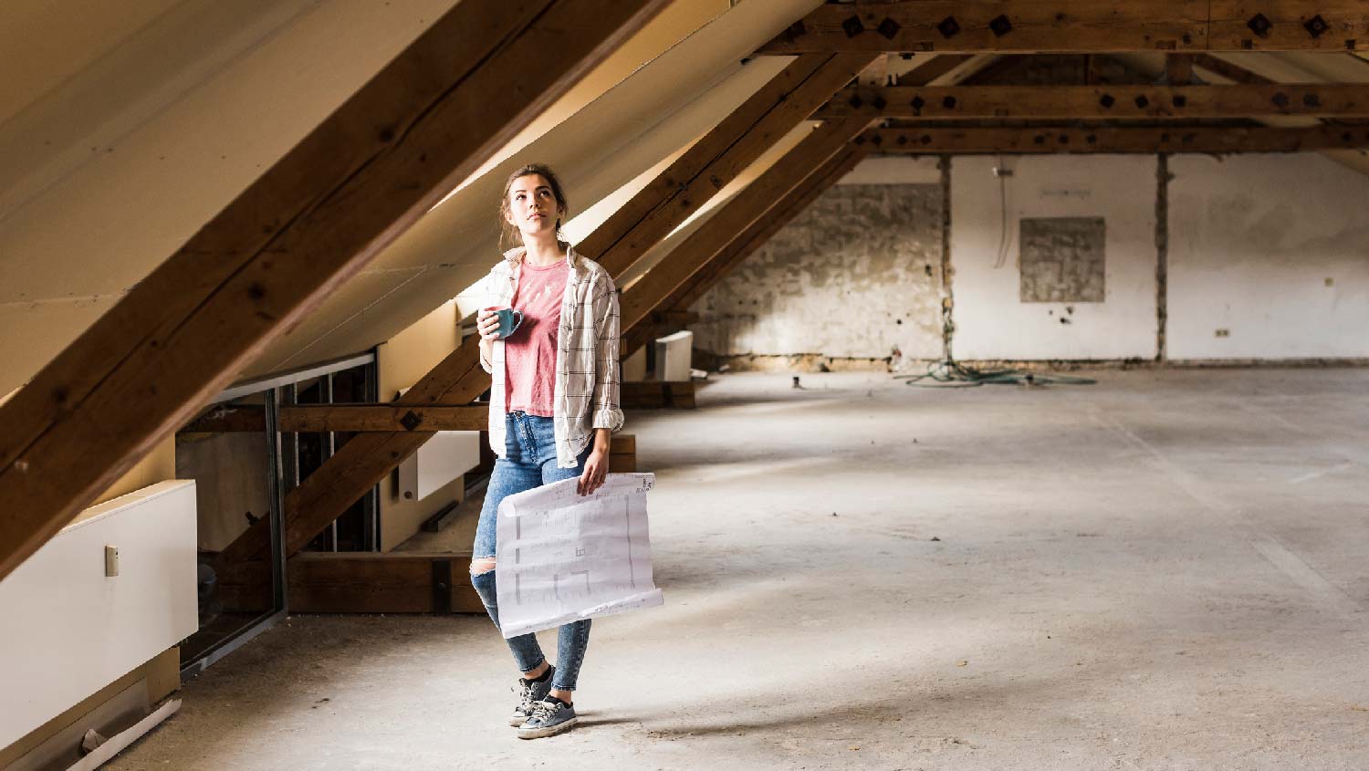 A woman examining an attic