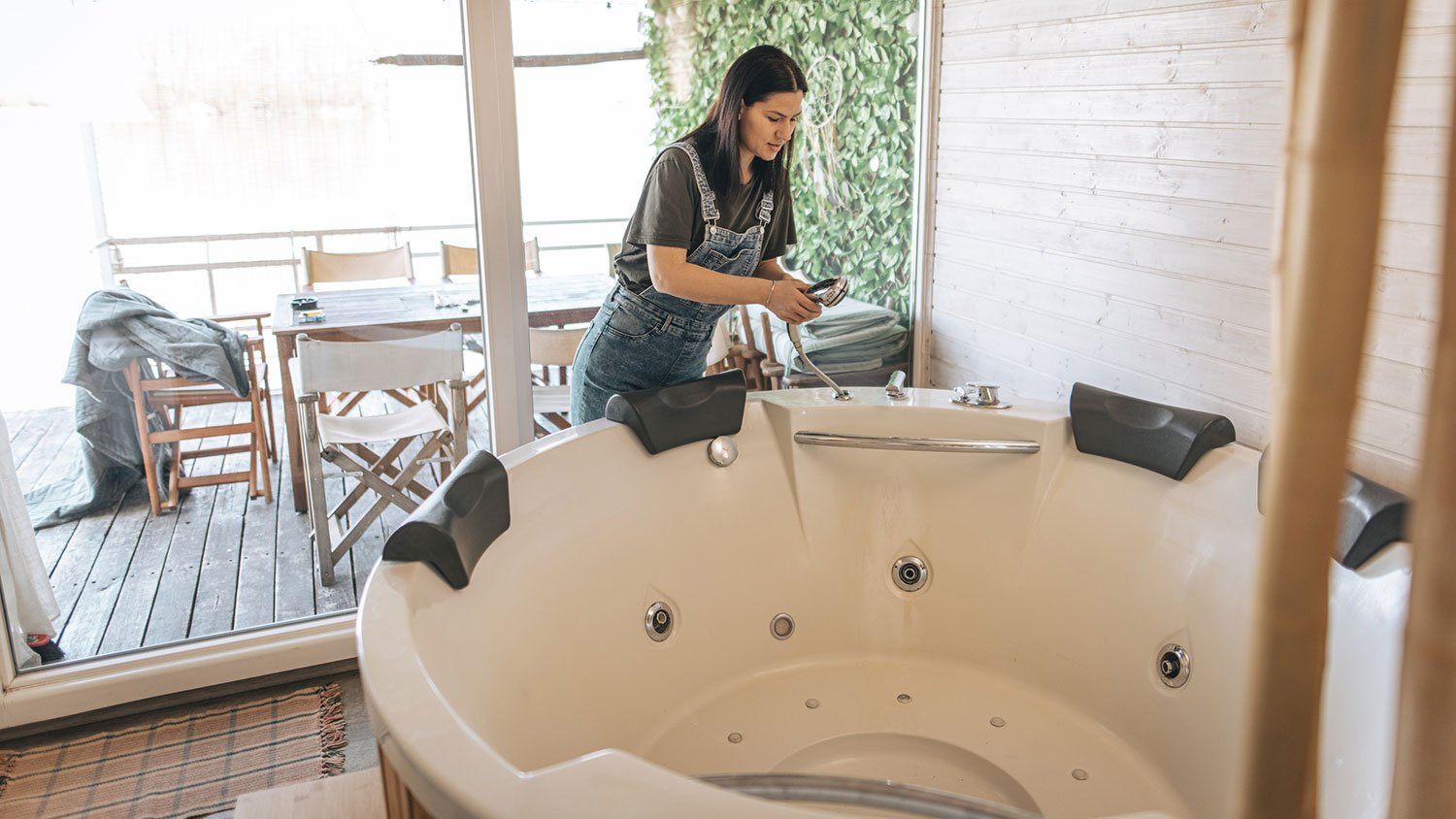 Woman filling up hot tub with fresh water