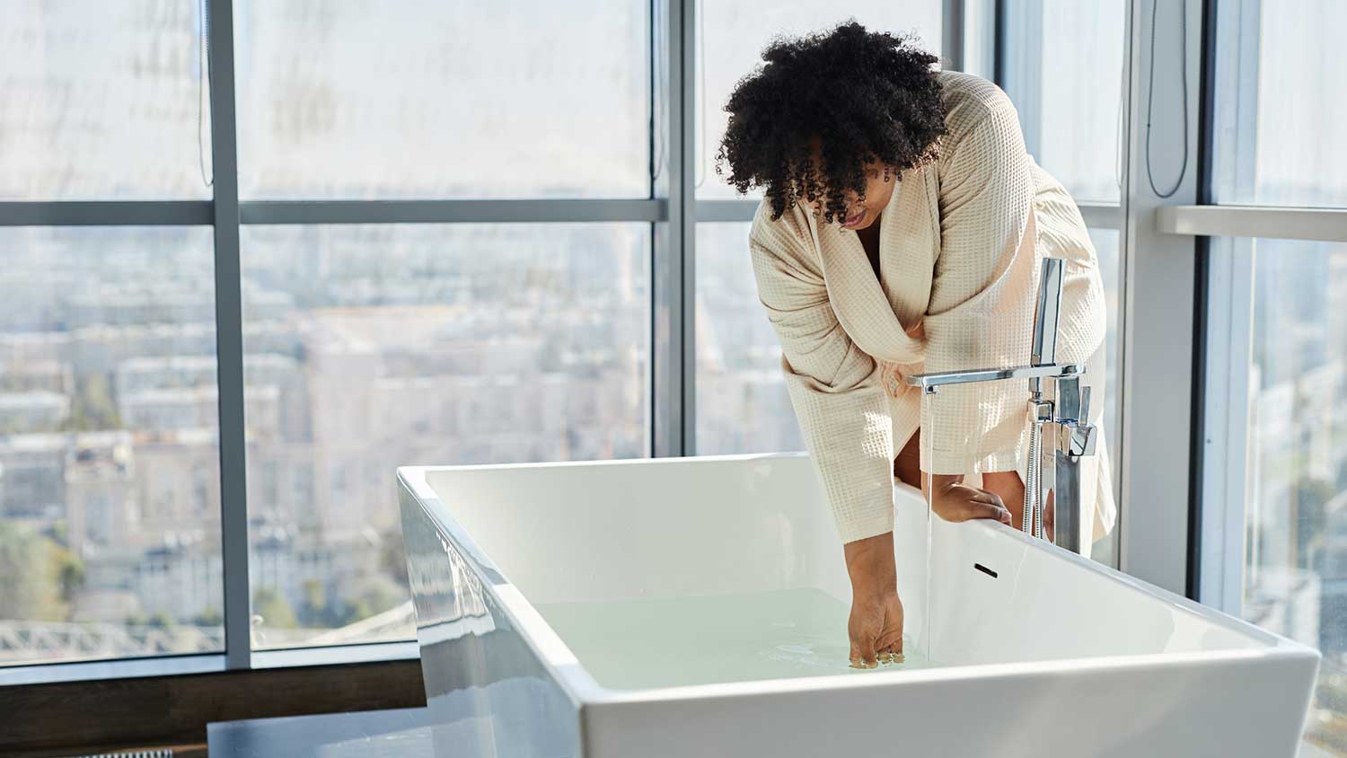 Woman filling bathtub