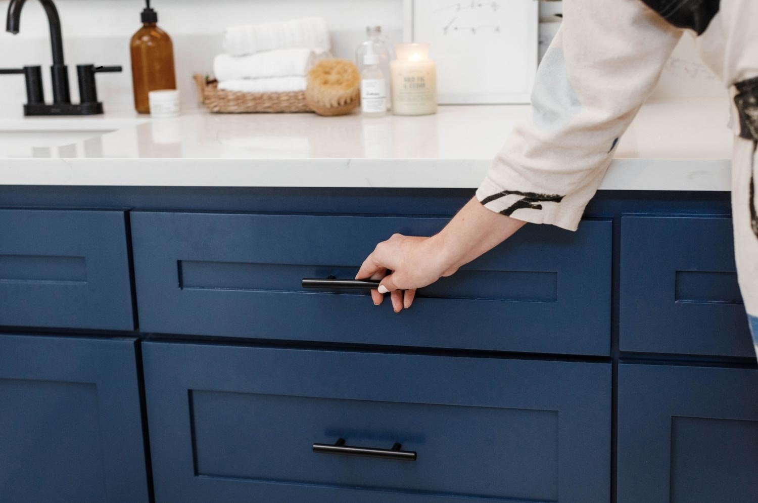 woman’s hand opening vanity drawer