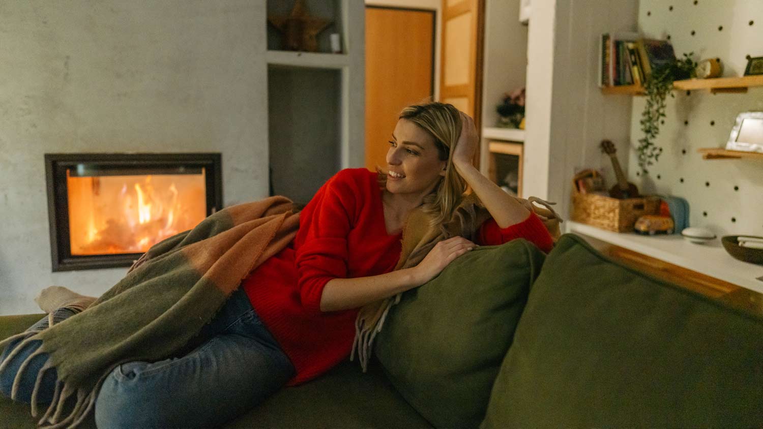 Woman cozy by the fireplace