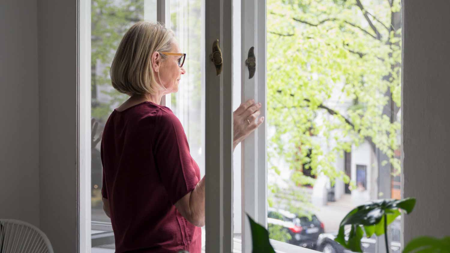 Woman at home opening the window