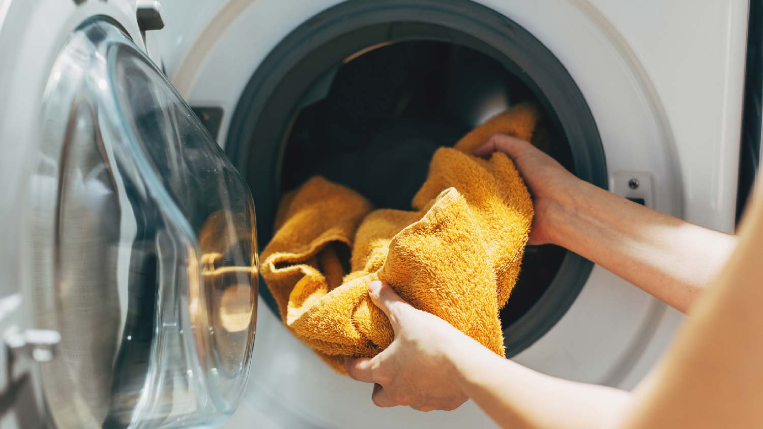 A woman loading a dryer