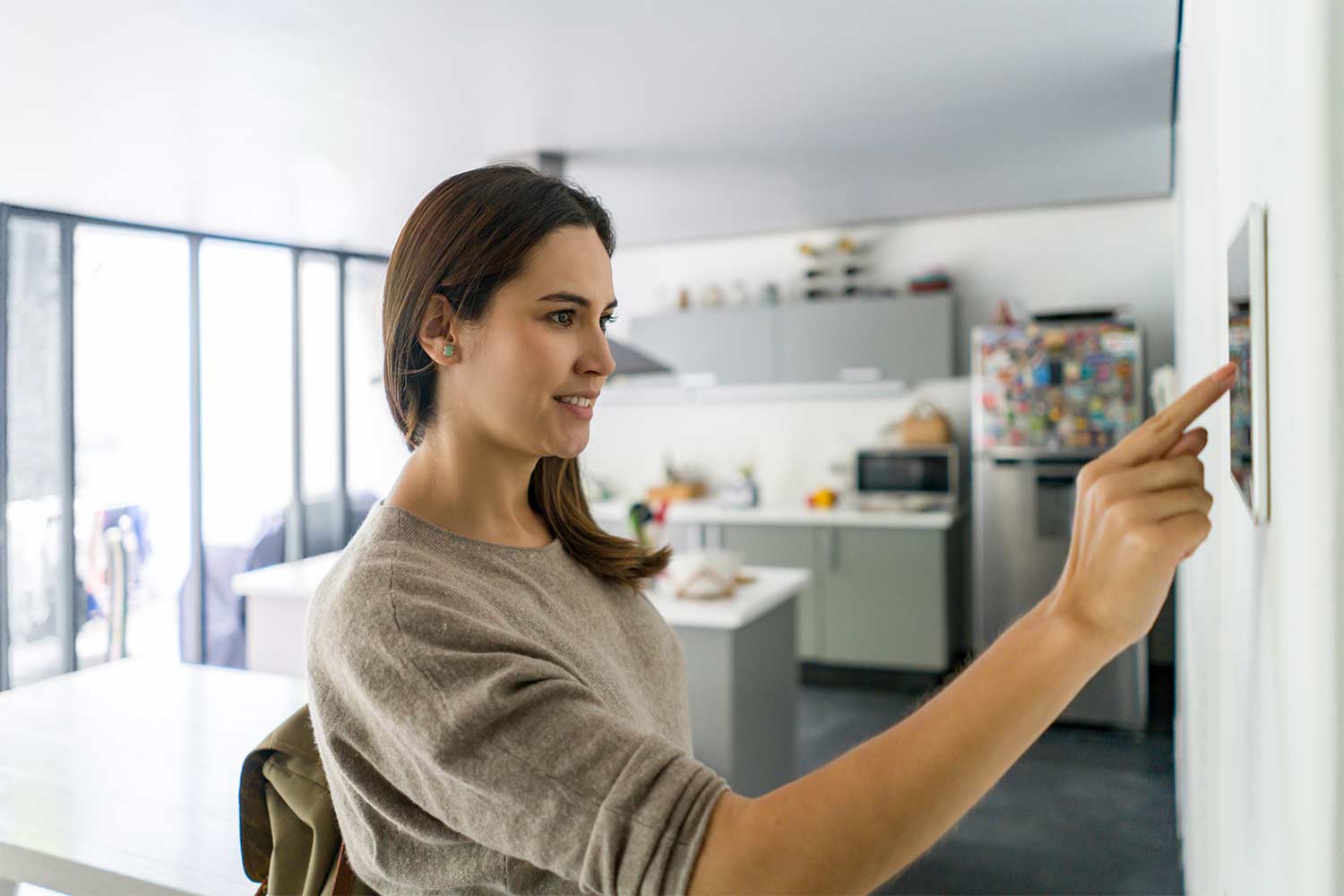 woman locking door with keys