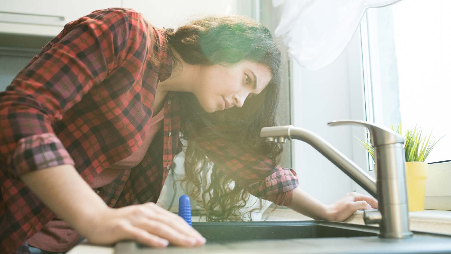 A woman looking down the sink