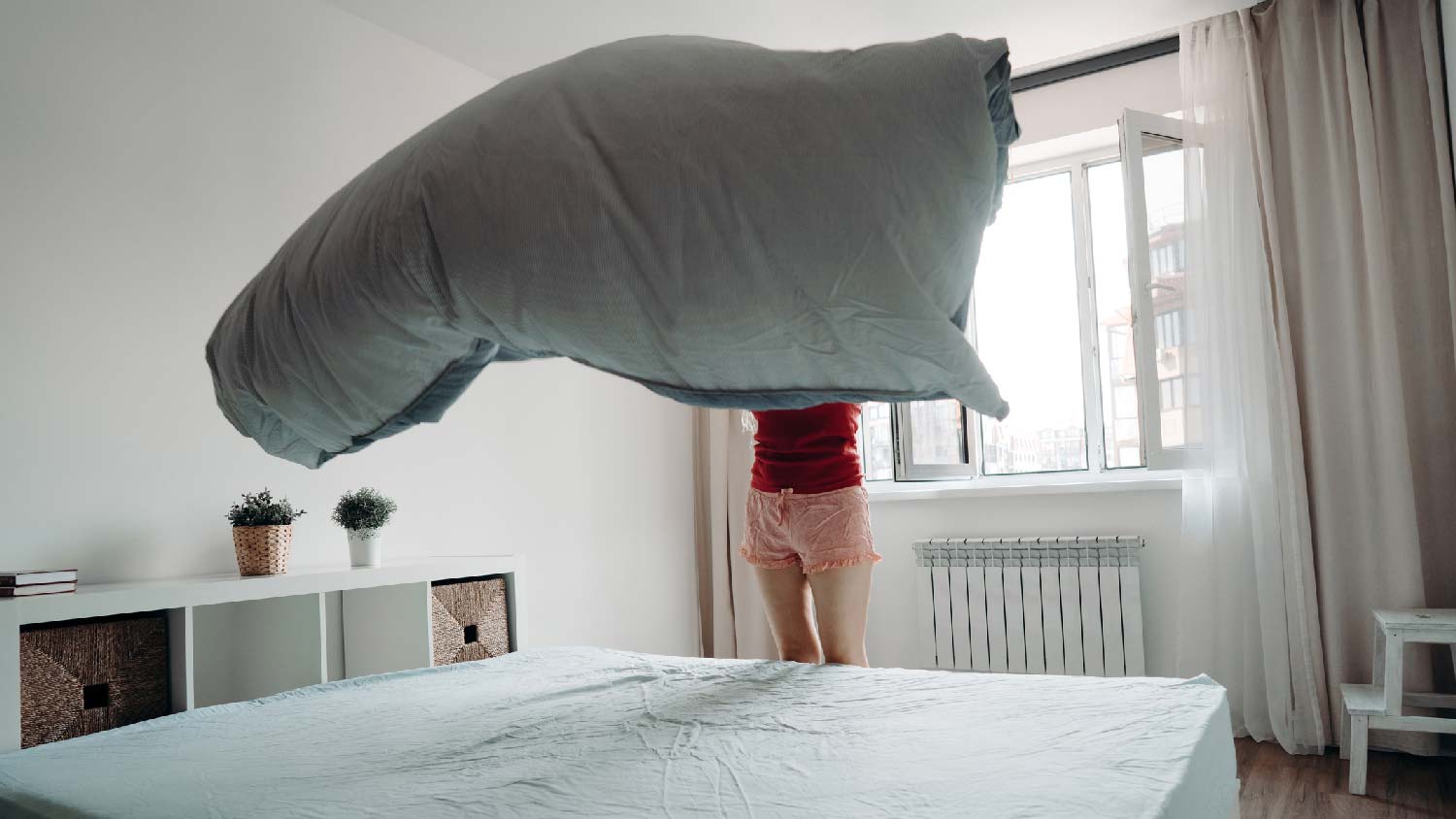 A woman makes her bed