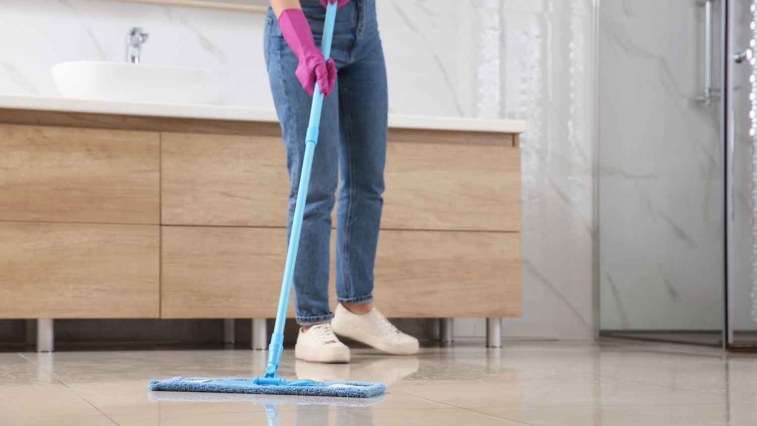 Woman mopping bathroom floor