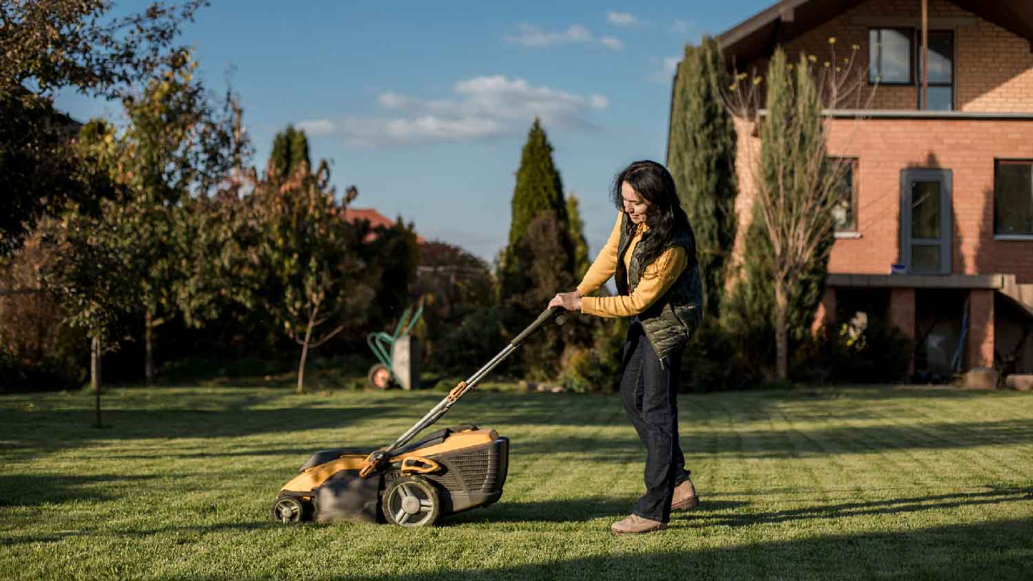 A woman mowing the lawn