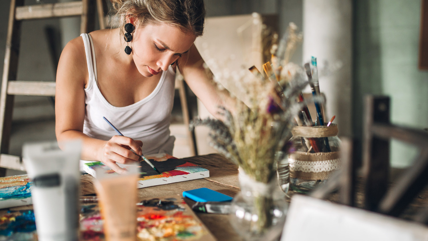 Woman working on canvas painting