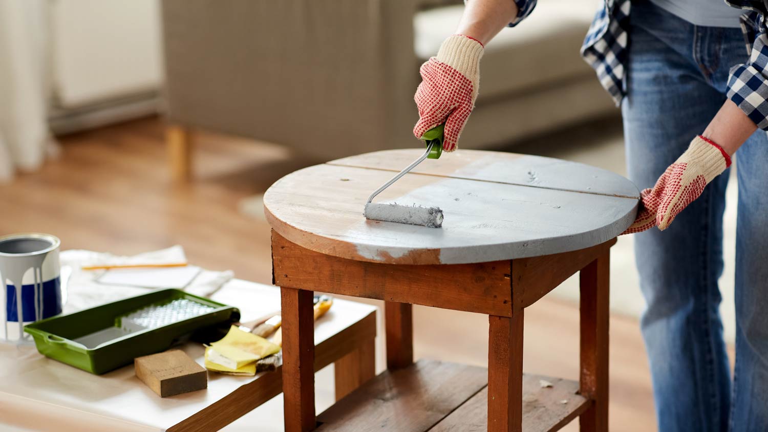 woman painting small wooden table