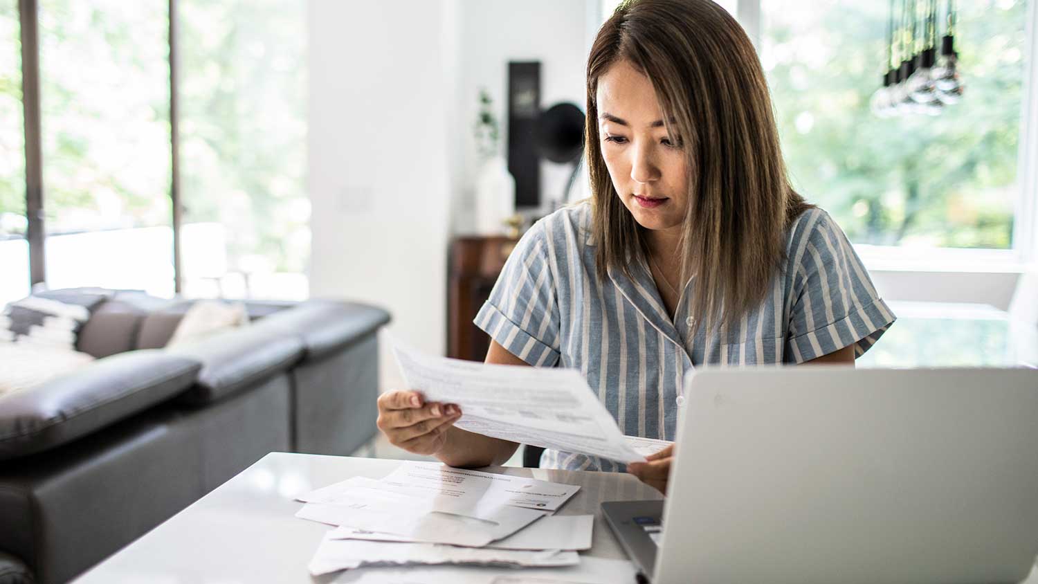 Woman at home paying utility bills