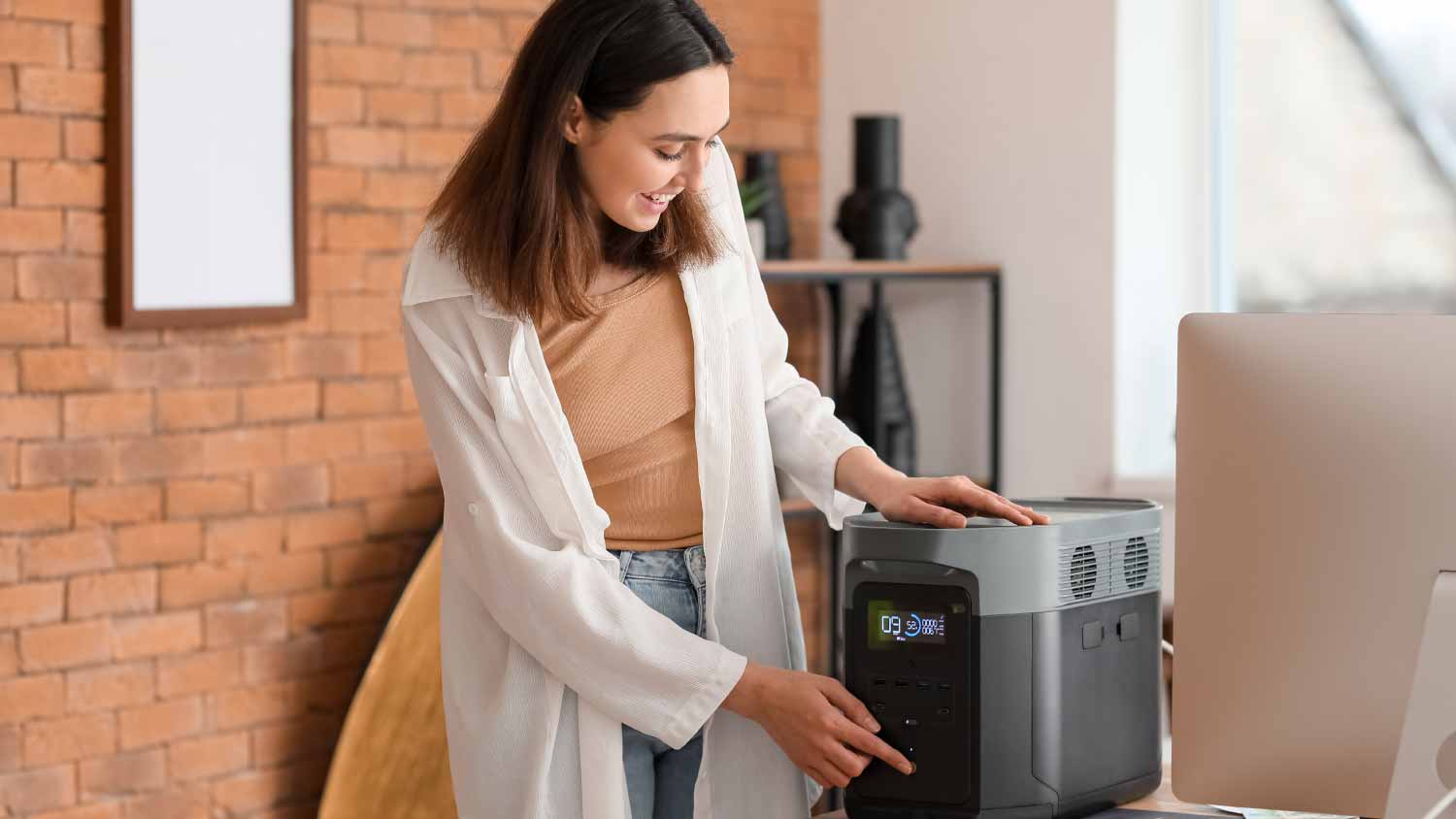 Young woman with portable power station