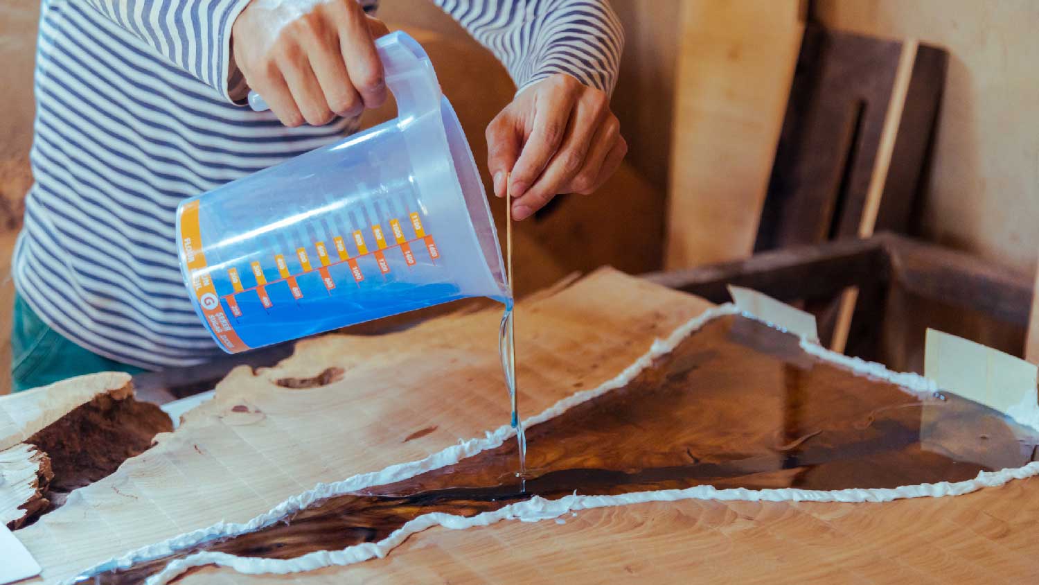 A woman pouring new epoxy on countertop