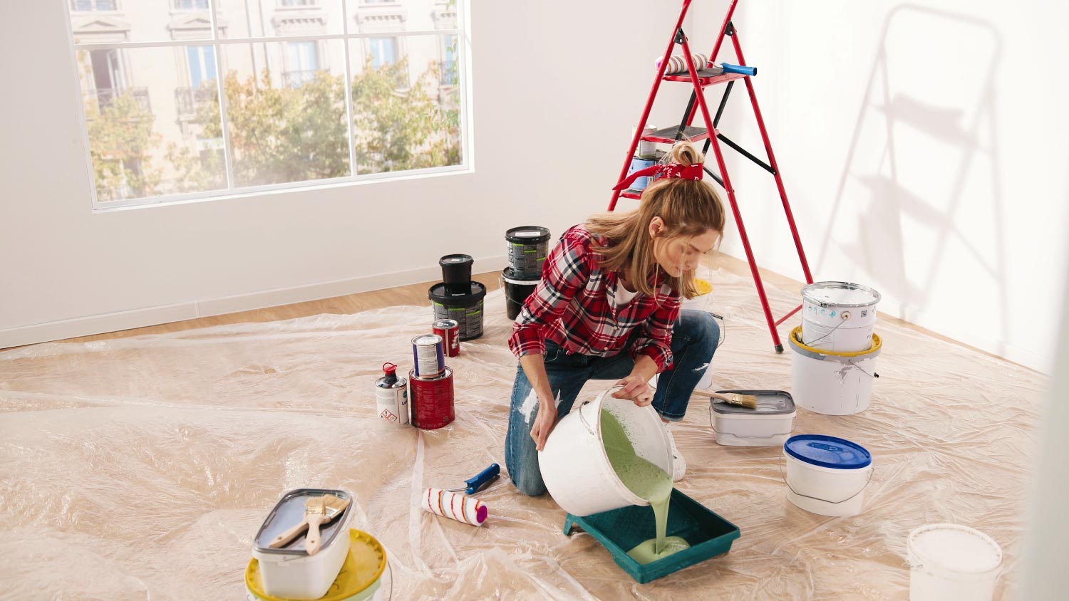 A woman pouring green paint