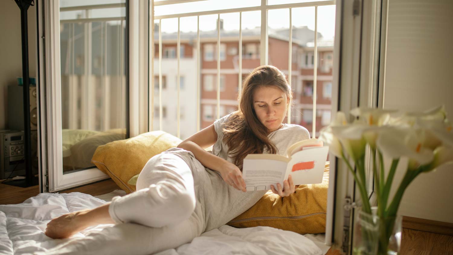 woman reading in window nook