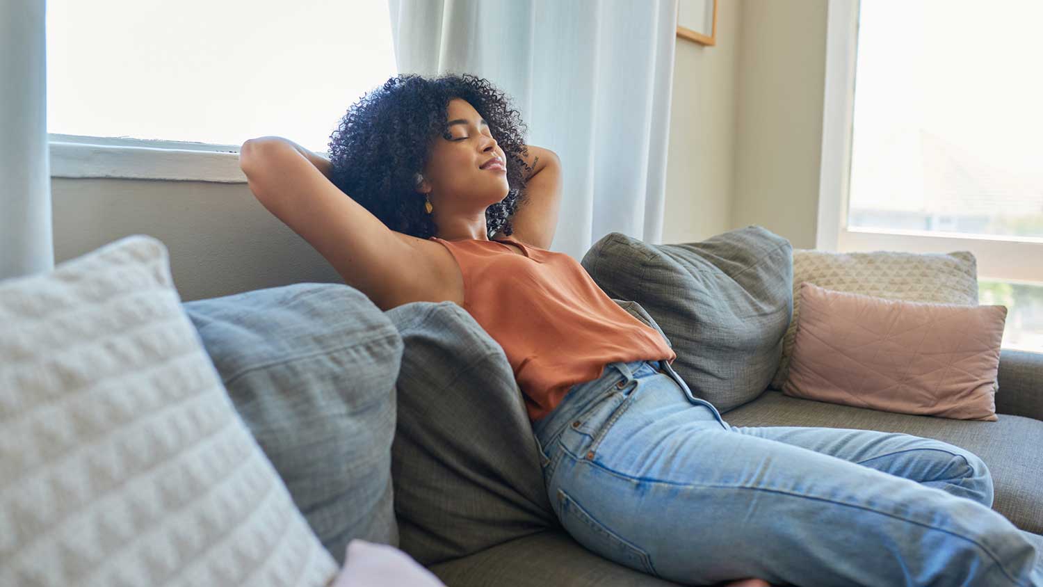 Young woman at home relaxing on a sofa 