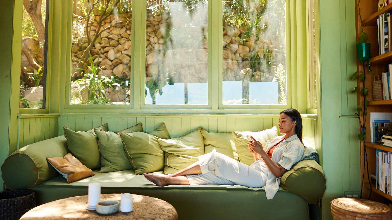 A woman relaxing on her sofa