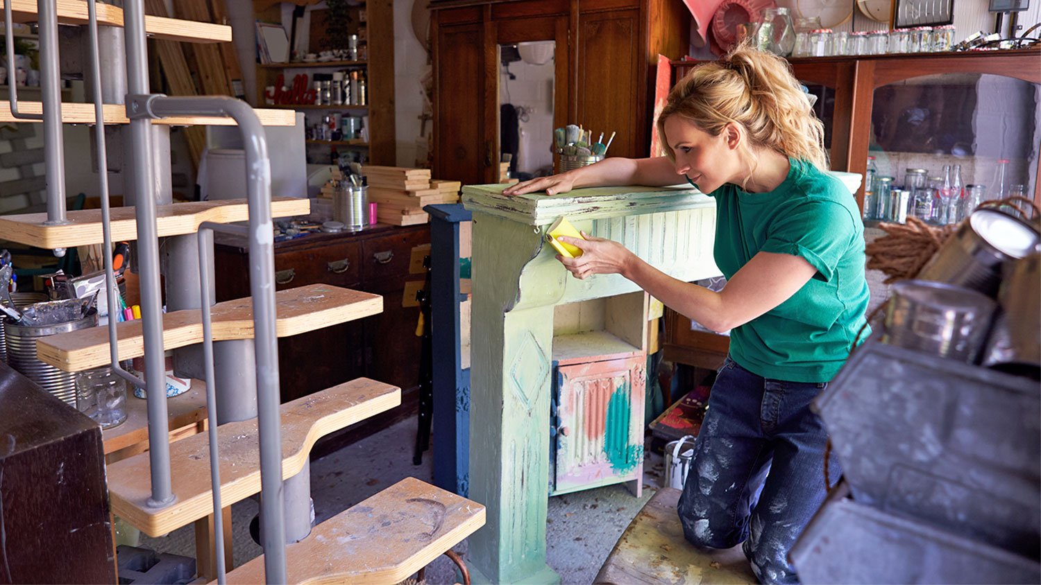 woman refinishing wood furniture