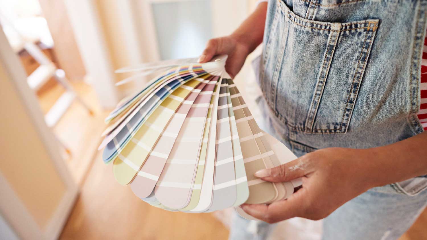 A woman selecting a color for her bedroom