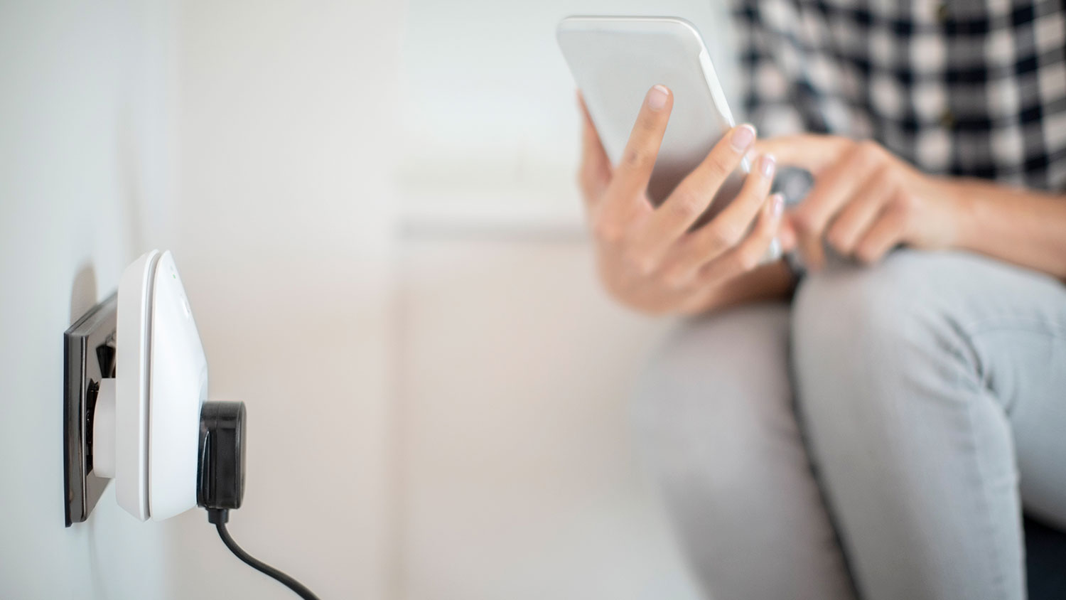 Woman setting up smart plug with her phone