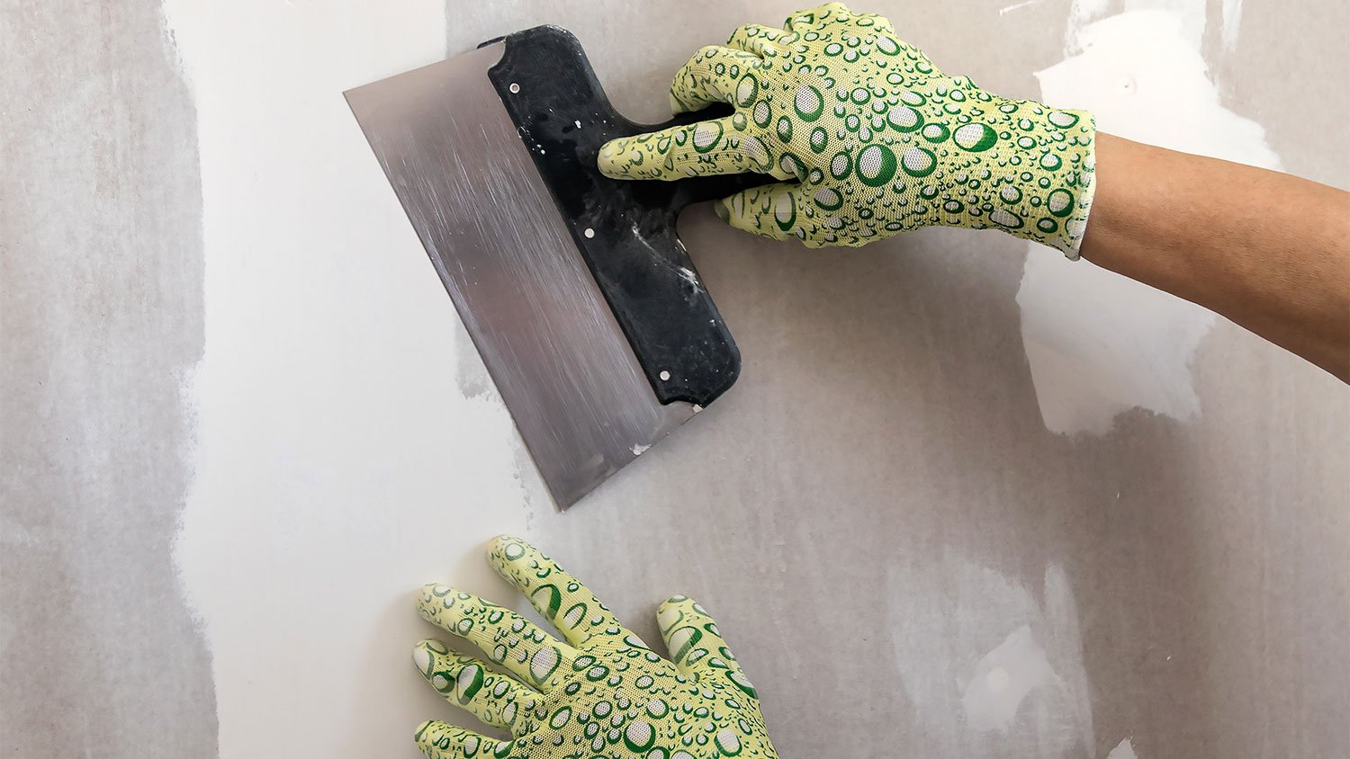 woman using spatula with spackle