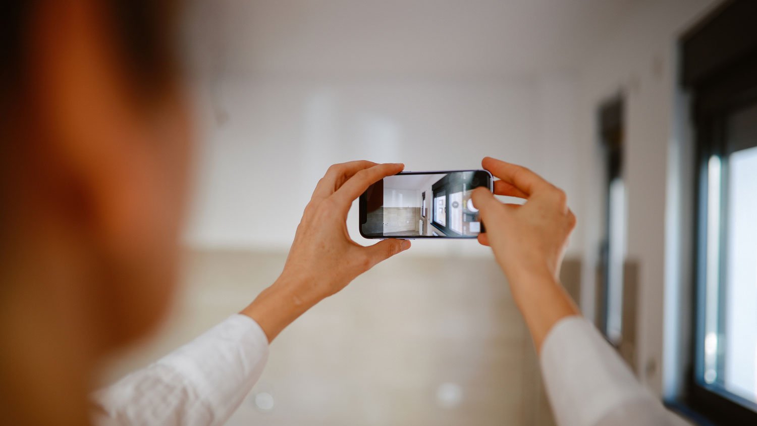 A woman taking photos of a basement