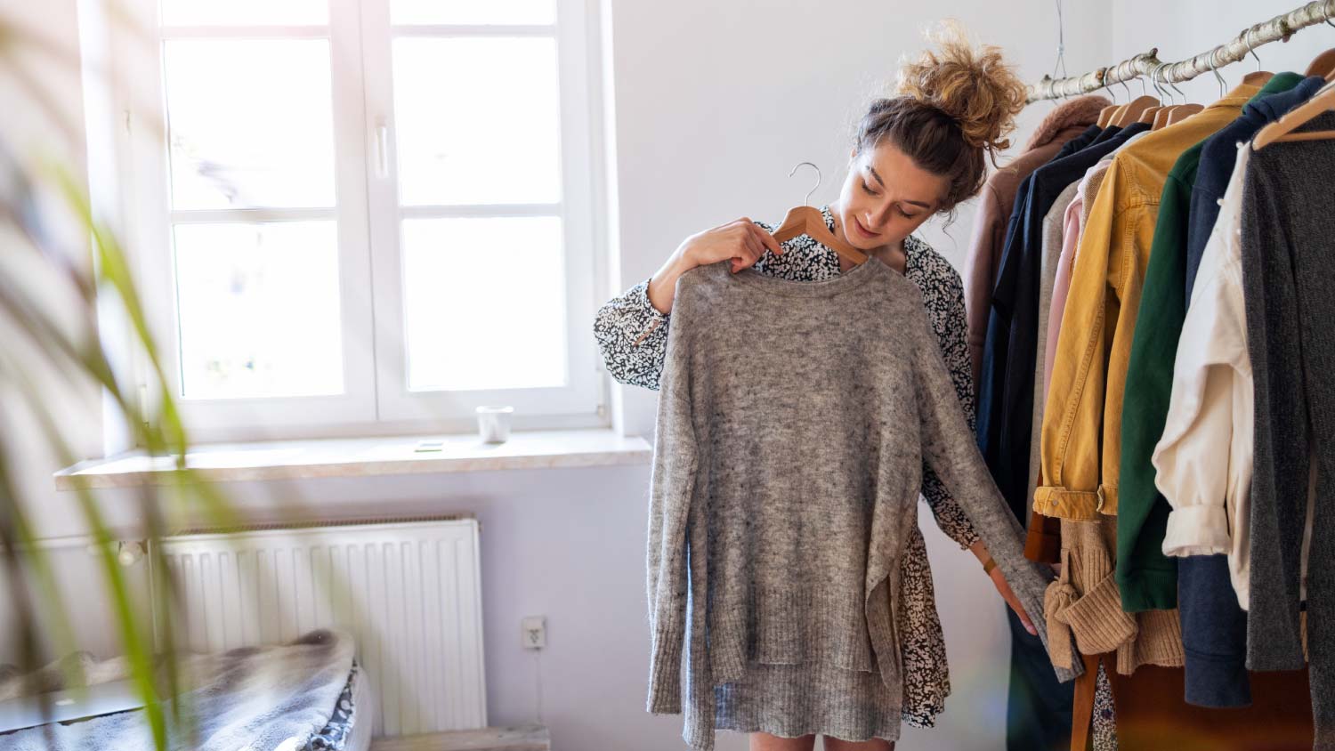 woman trying on clothes in her room