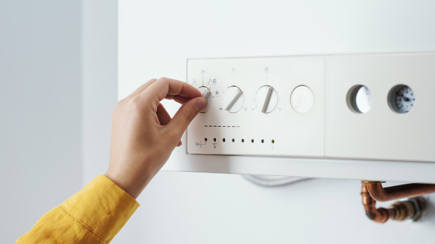 A woman turning off the boiler