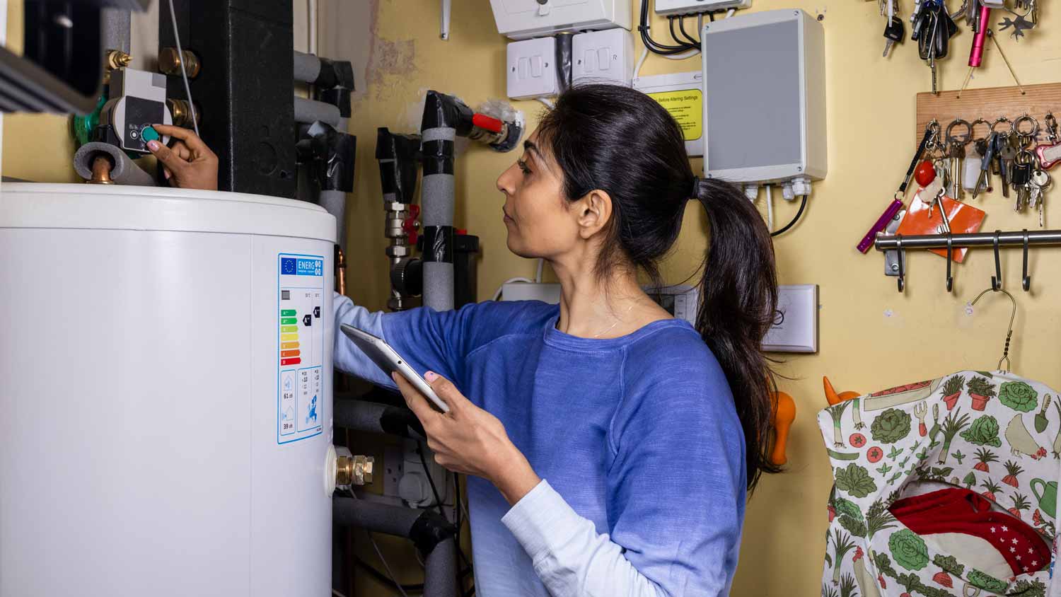 A woman turning off the water heater