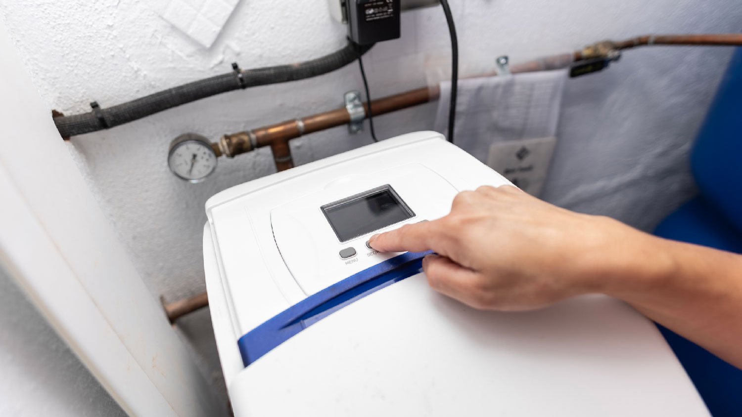 A woman turning off the water softener